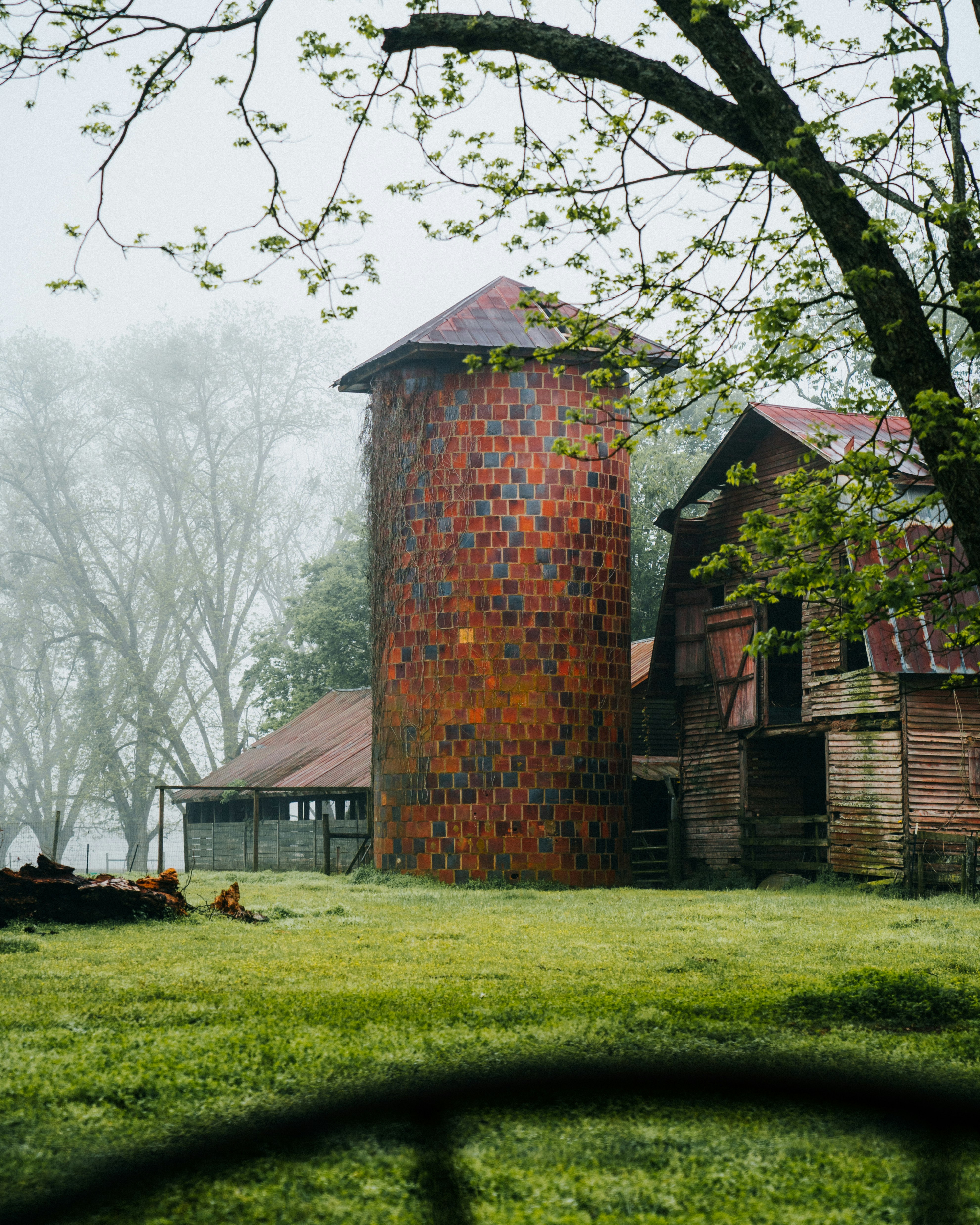 brown concrete tower beside house